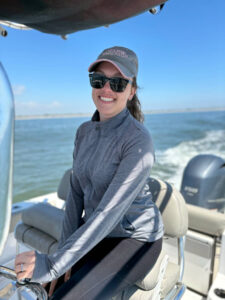 Presenter Melissa Laurino is shown on a motorboat at sea.